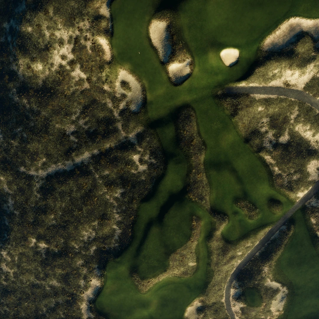 Aerial view of a lush, green golf course with sandy bunkers and winding paths surrounded by natural terrain and sparse vegetation.