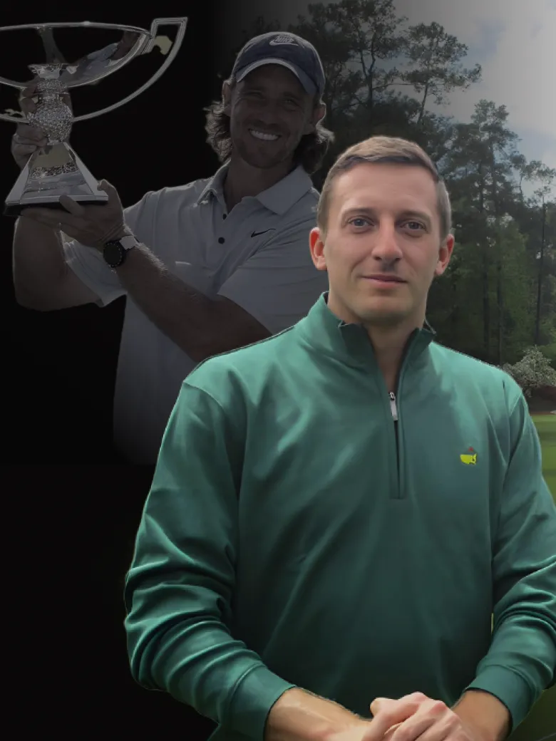 Tom Boys in a green jacket stands in front Tommy Fleetwood holding a trophy against a black background.